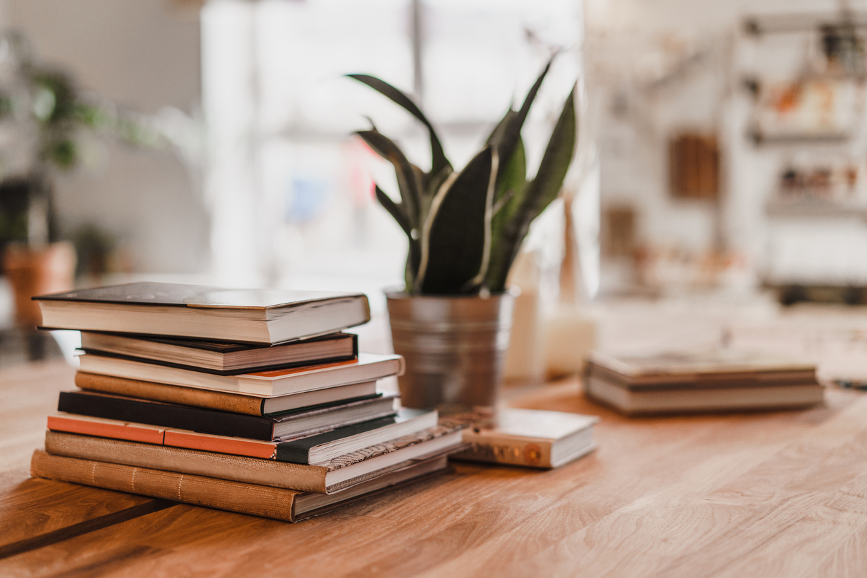 Stack of books on table in the room.